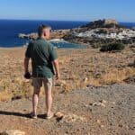Vista panoramica di un uomo che osserva il mare e il castello di Roca in Corsica.